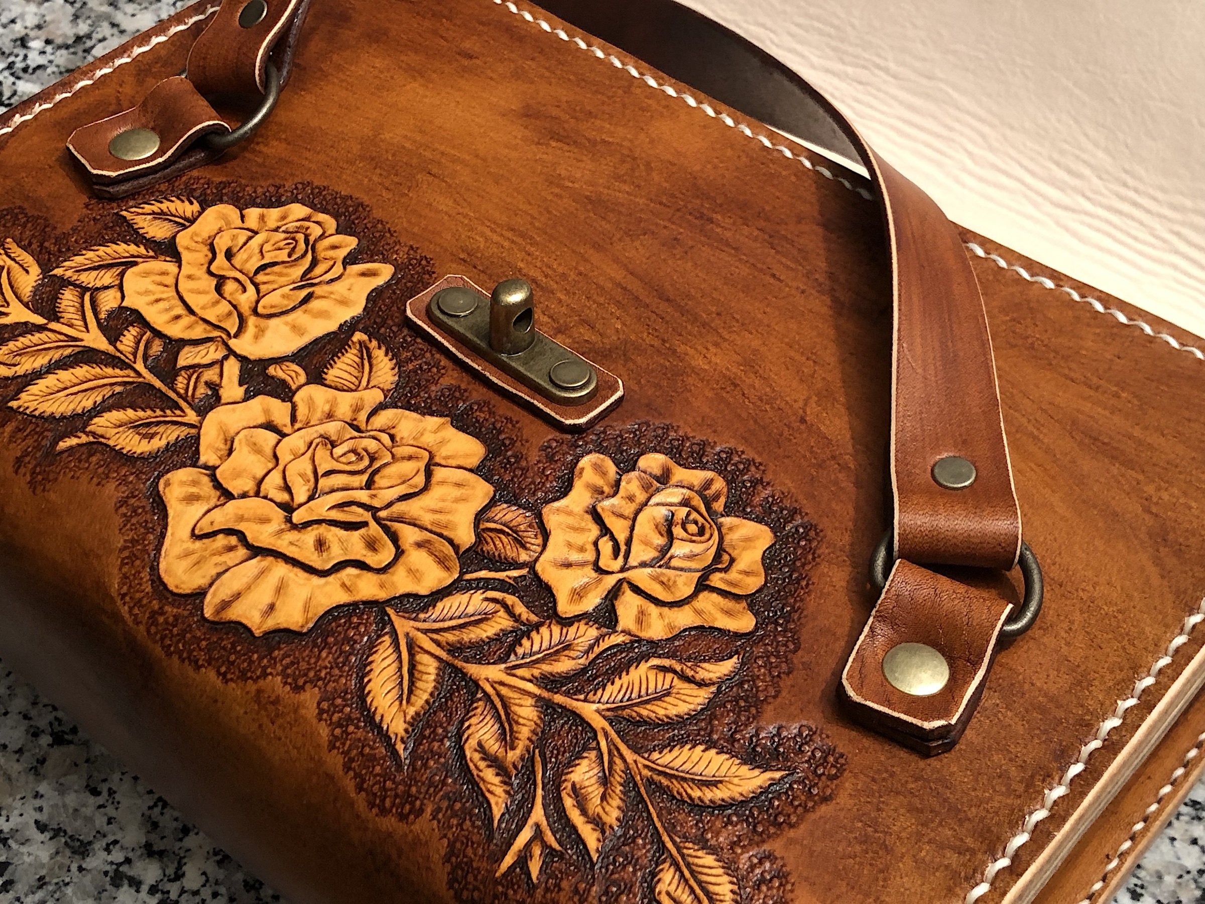 Hand-tooled rose carving on leather