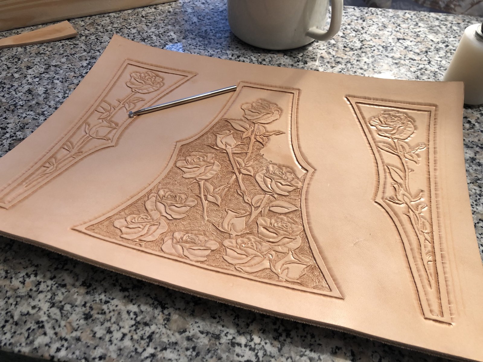 Hand-tooling a floral pattern into leather